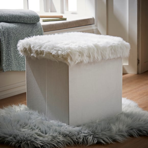 console table with chairs behind couch