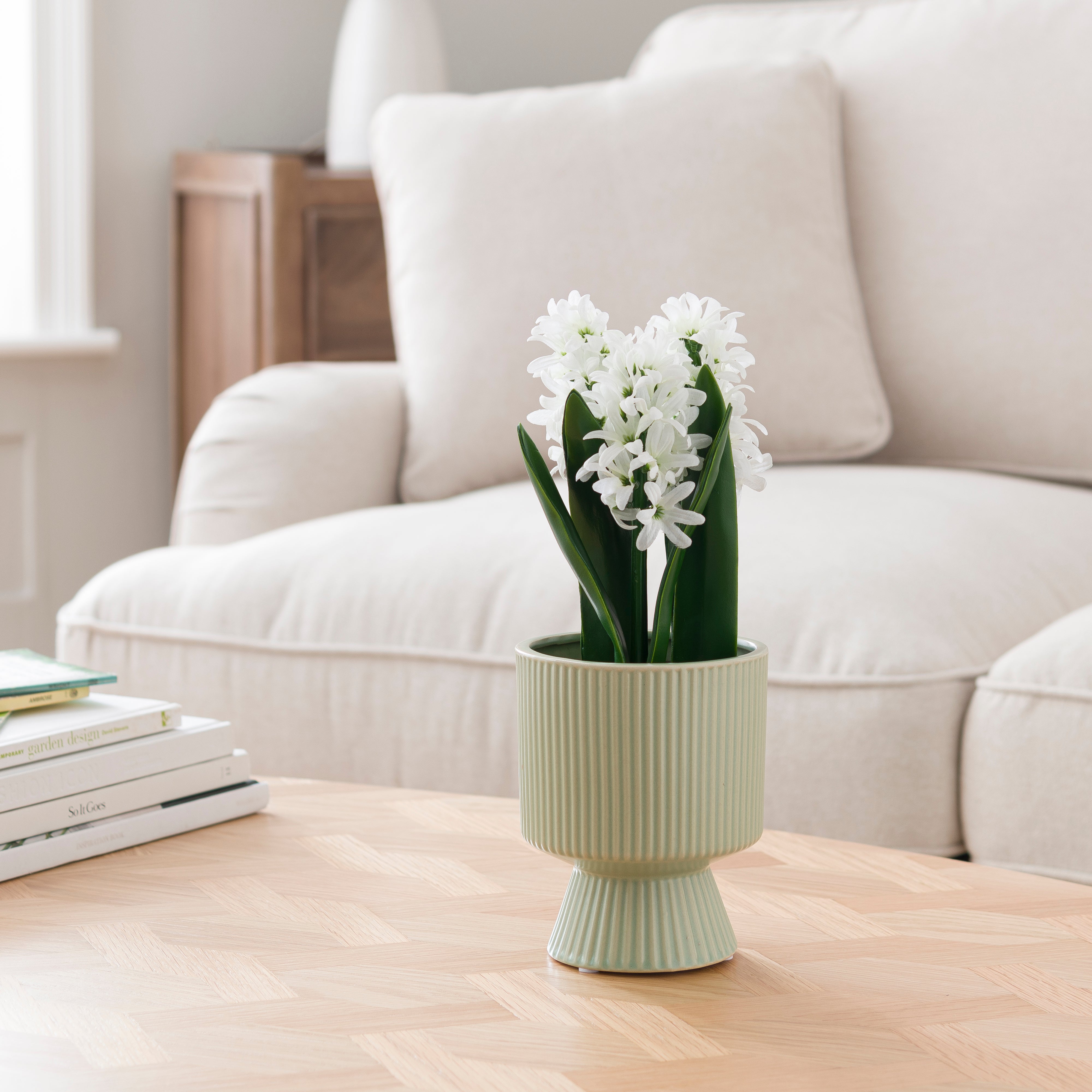 Artificial White Hyacinth in Ribbed Green Ceramic Plant Pot