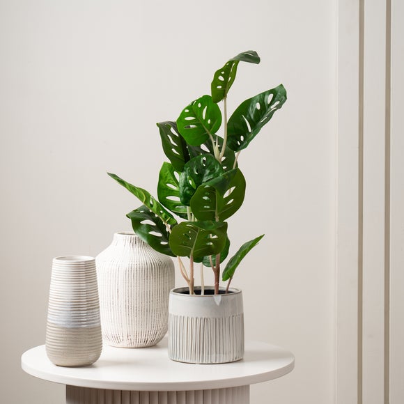 Click to view product details and reviews for Artificial Real Touch Monstera In Black Plastic Plant Pot.