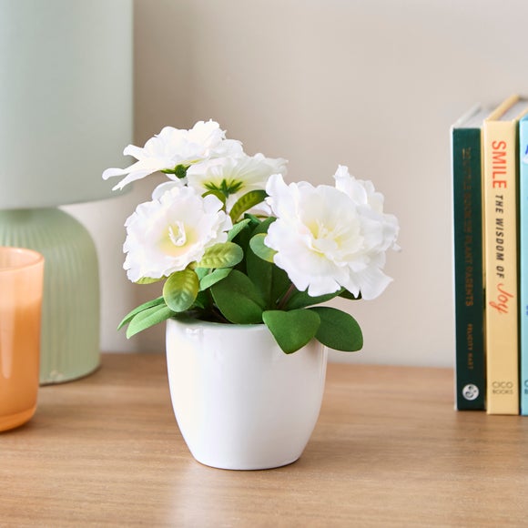 Click to view product details and reviews for Artificial Blossom Floral In White Ceramic Plant Pot.
