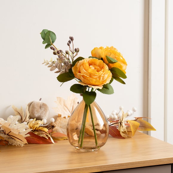 Click to view product details and reviews for Artificial Yellow Rose Arrangement In Smoked Glass Vase.