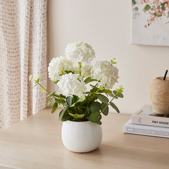Click to view product details and reviews for Artificial Hydrangea Eucalyptus In Ribbed Plant Pot.